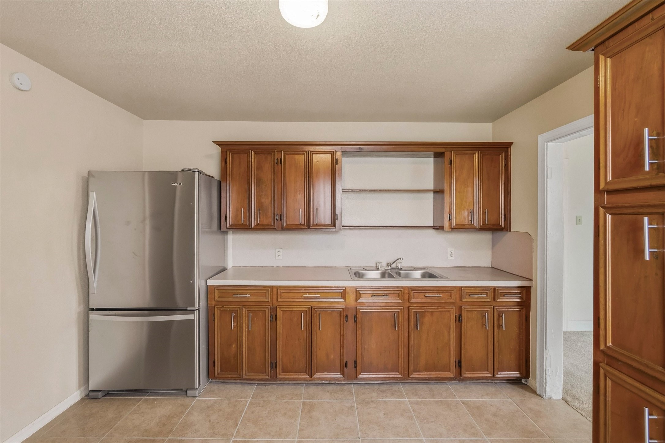 7215 Apache Street Houston, TX 77028 - Photo 5 of 20 a kitchen with a sink a refrigerator and cabinets