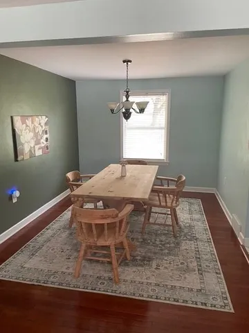 a dining room with a table and chandelier