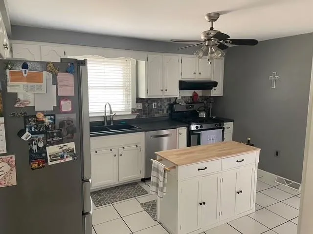 a kitchen with a sink appliances and cabinets