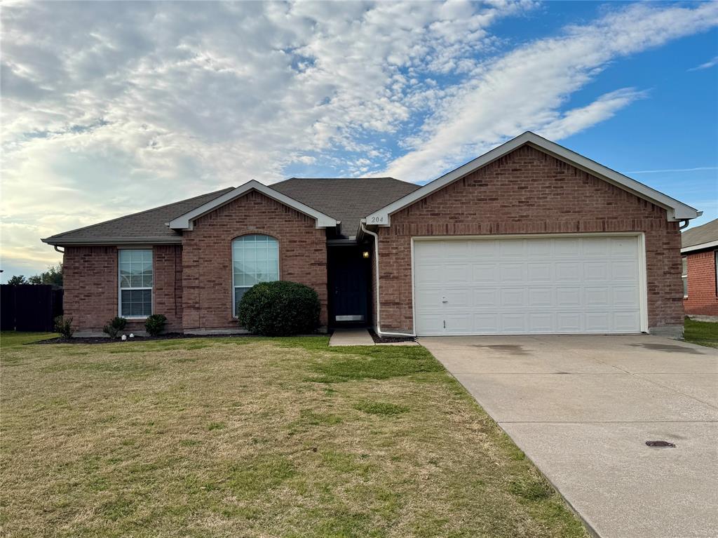 204 South Chestnut Street Forney, TX 75126 - Photo 1 of 19 a front view of a house with a yard and garage