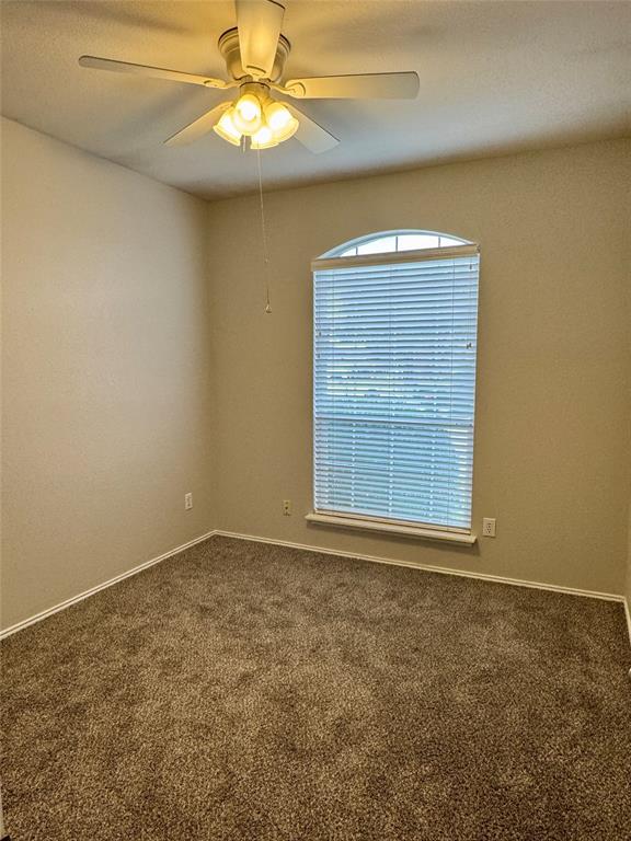 204 South Chestnut Street Forney, TX 75126 - Photo 14 of 19 an empty room with a window and chandelier fan