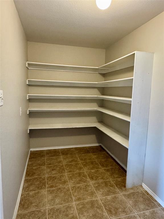 204 South Chestnut Street Forney, TX 75126 - Photo 16 of 19 a view of room with racks on the wall