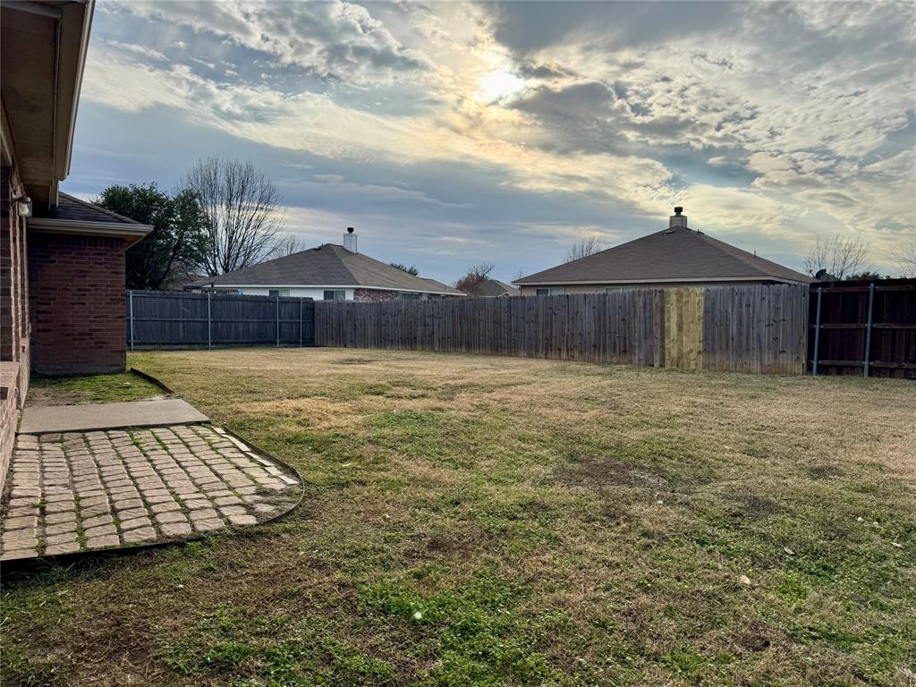 204 South Chestnut Street Forney, TX 75126 - Photo 18 of 19 a view of a backyard with a barbeque grill and a fireplace