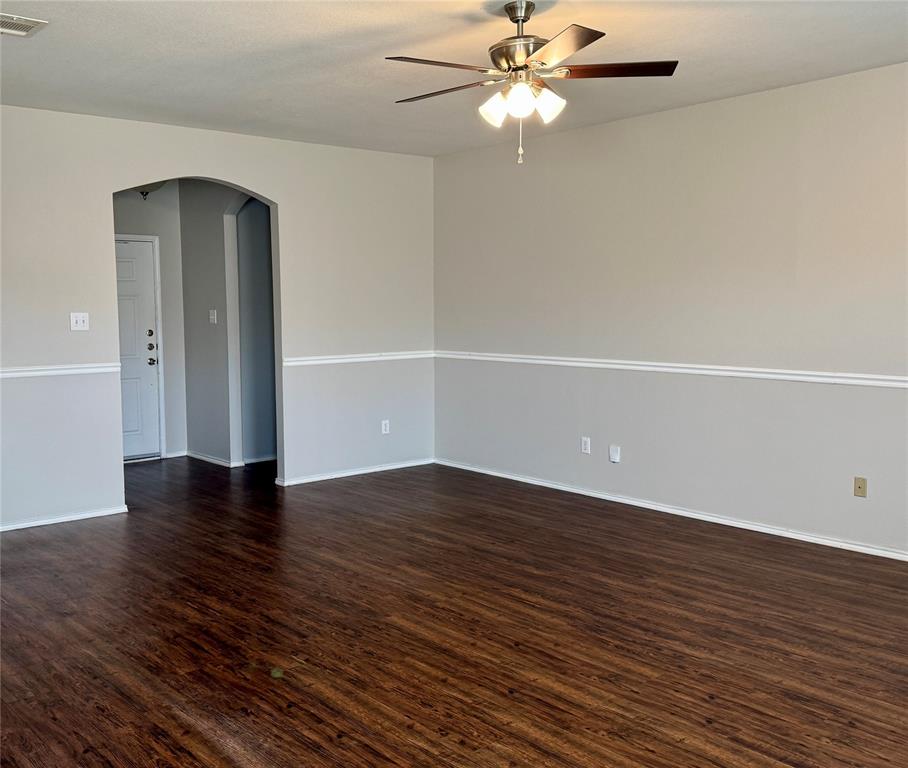204 South Chestnut Street Forney, TX 75126 - Photo 2 of 19 a view of an empty room with wooden floor and a ceiling fan