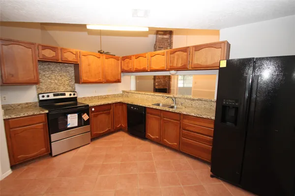 a kitchen with stainless steel appliances granite countertop a stove and a sink
