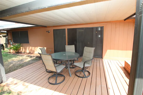 a view of a chairs in wooden deck