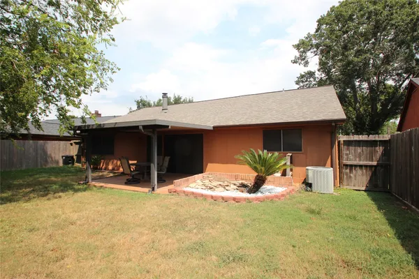 a view of a house with a yard and sitting area