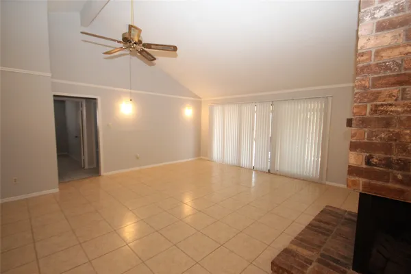 a view of an empty room with a fireplace