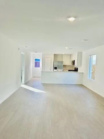 a view of a kitchen with a sink and a refrigerator