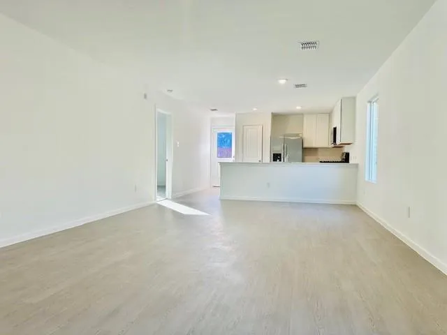 a view of a kitchen with a sink and cabinets