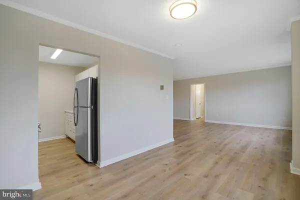 an empty room with wooden floor and a window