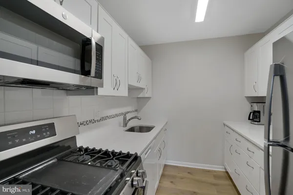 a kitchen with a stove and a microwave