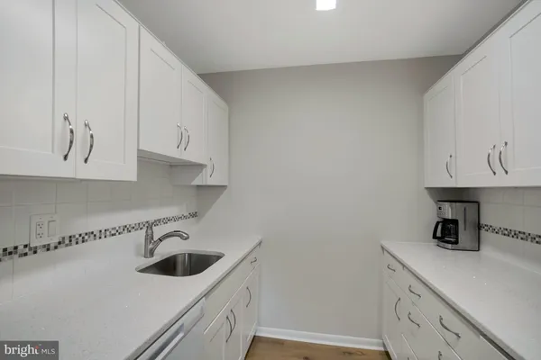 a kitchen with a sink and cabinets
