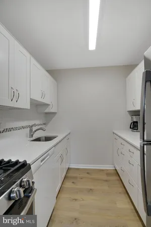 a kitchen with granite countertop a stove and a sink