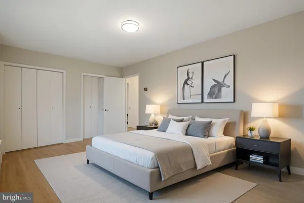 a bedroom with a bed and a night stand