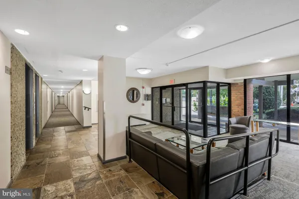 a view of a hallway with furniture