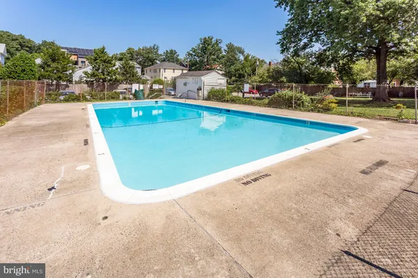 a view of a swimming pool with lounge chair