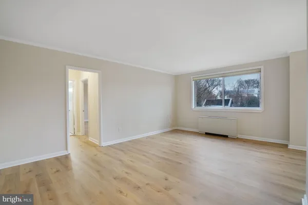 an empty room with windows and closet