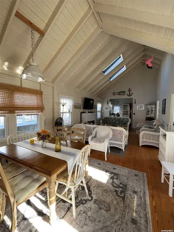 a room with lots of tables a chandelier and pool table