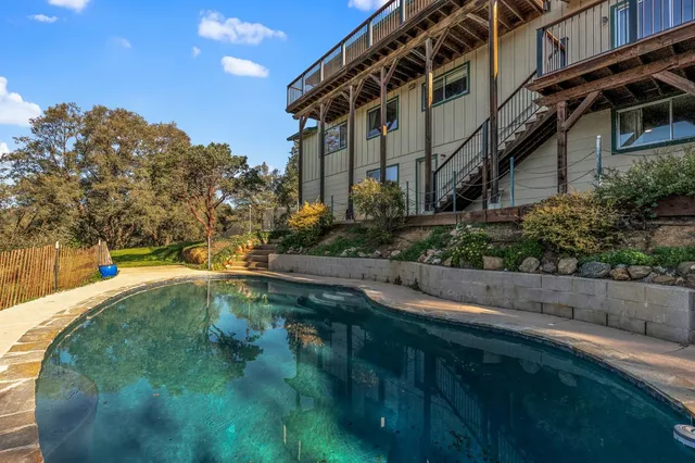 a view of yard with swimming pool and outdoor seating
