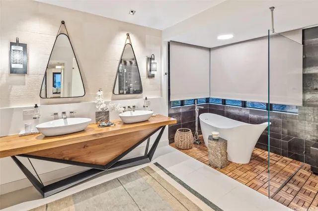 a bathroom with a double vanity sink a mirror and a bathtub