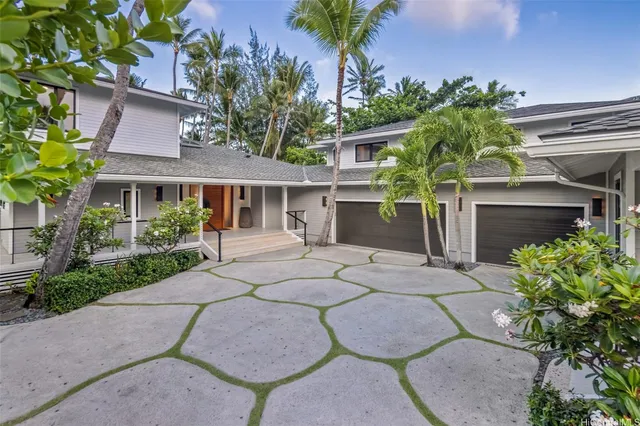 a view of a house with a yard and potted plants