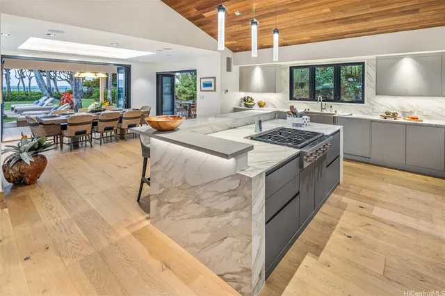 a open kitchen with stainless steel appliances granite countertop a stove and a refrigerator