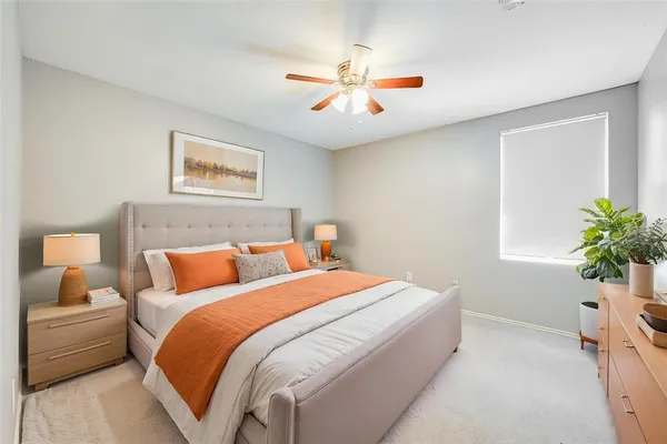 a bedroom with a large bed and a chandelier