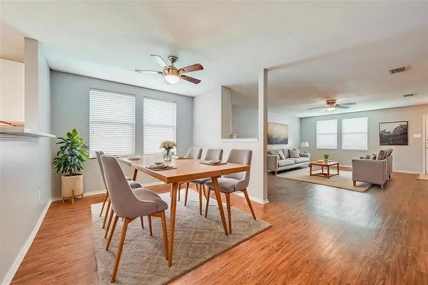 a view of a dining room with furniture and wooden floor