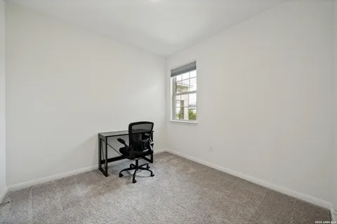 a view of room with chair and piano