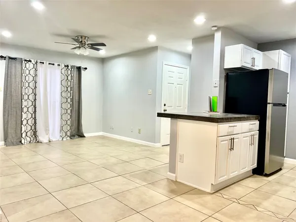 a kitchen with cabinets and wooden floor