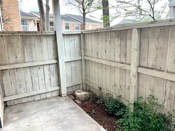 a backyard of a house with wooden fence
