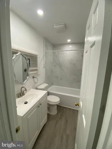 a bathroom with a double vanity sink toilet mirror and shower