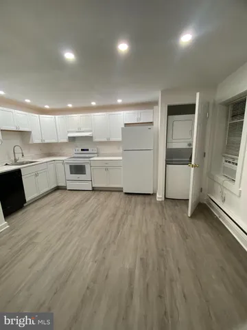 a kitchen with a wooden floor and window