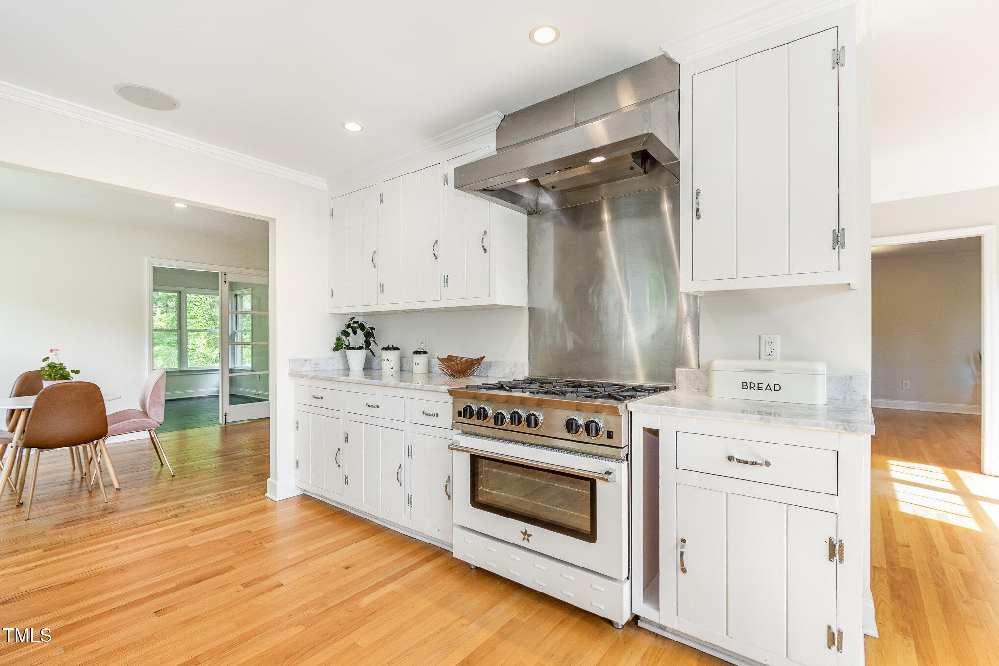 804 Old Mill Road Chapel Hill, NC 27514 - Photo 9 of 30 a kitchen with white cabinets and white appliances