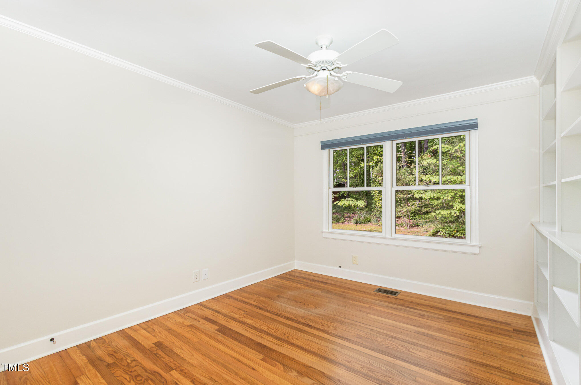 804 Old Mill Road Chapel Hill, NC 27514 - Photo 16 of 30 an empty room with wooden floor fan and windows