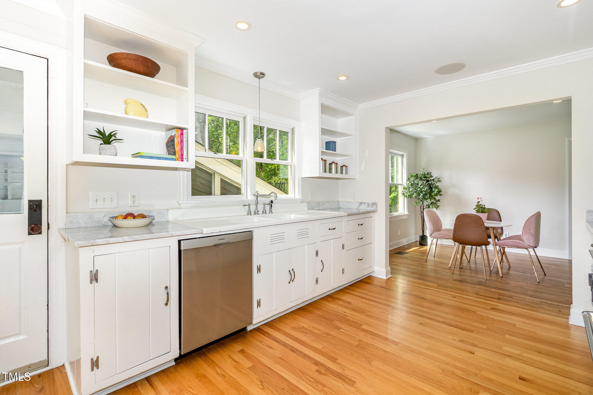 804 Old Mill Road Chapel Hill, NC 27514 - Photo 8 of 30 a kitchen with a dining table chairs and white cabinets