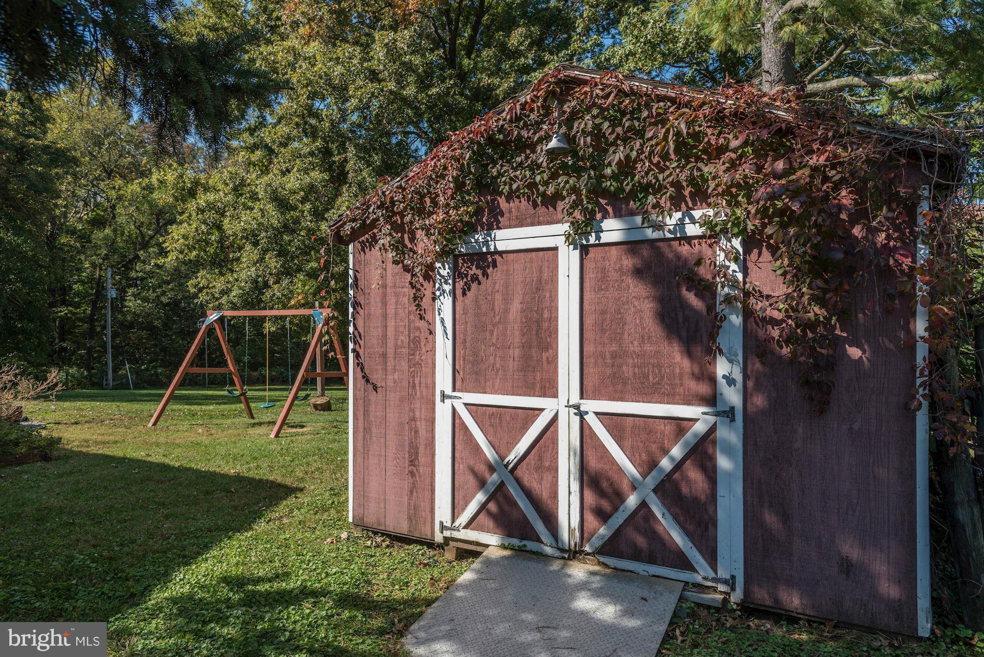 16869 Ivandale Road Hamilton, VA 20158 - Photo 14 of 21 a view of a backyard with a slide and a tree