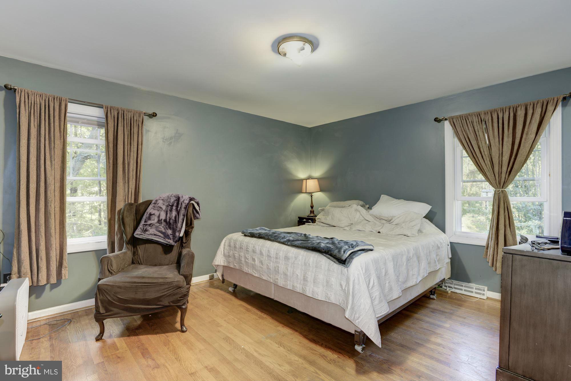 16869 Ivandale Road Hamilton, VA 20158 - Photo 9 of 21 a bedroom with a bed and a chair