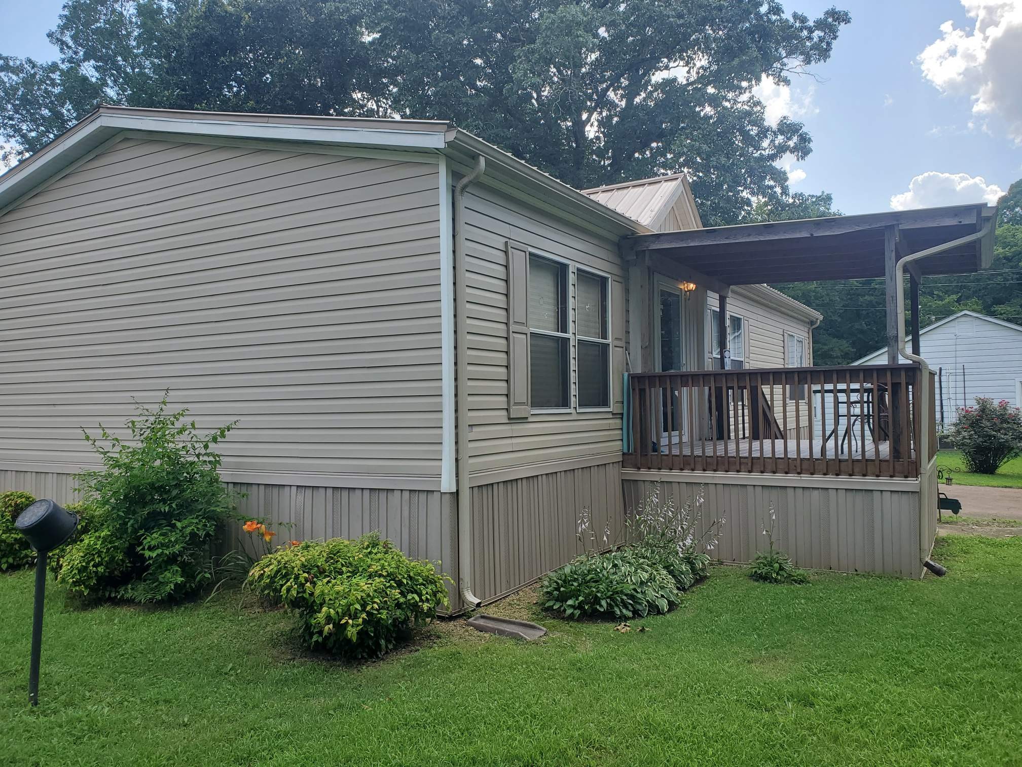 411 West Martin Road Collinwood, TN 38450 - Photo 2 of 23 a view of a house with brick walls and a yard with plants