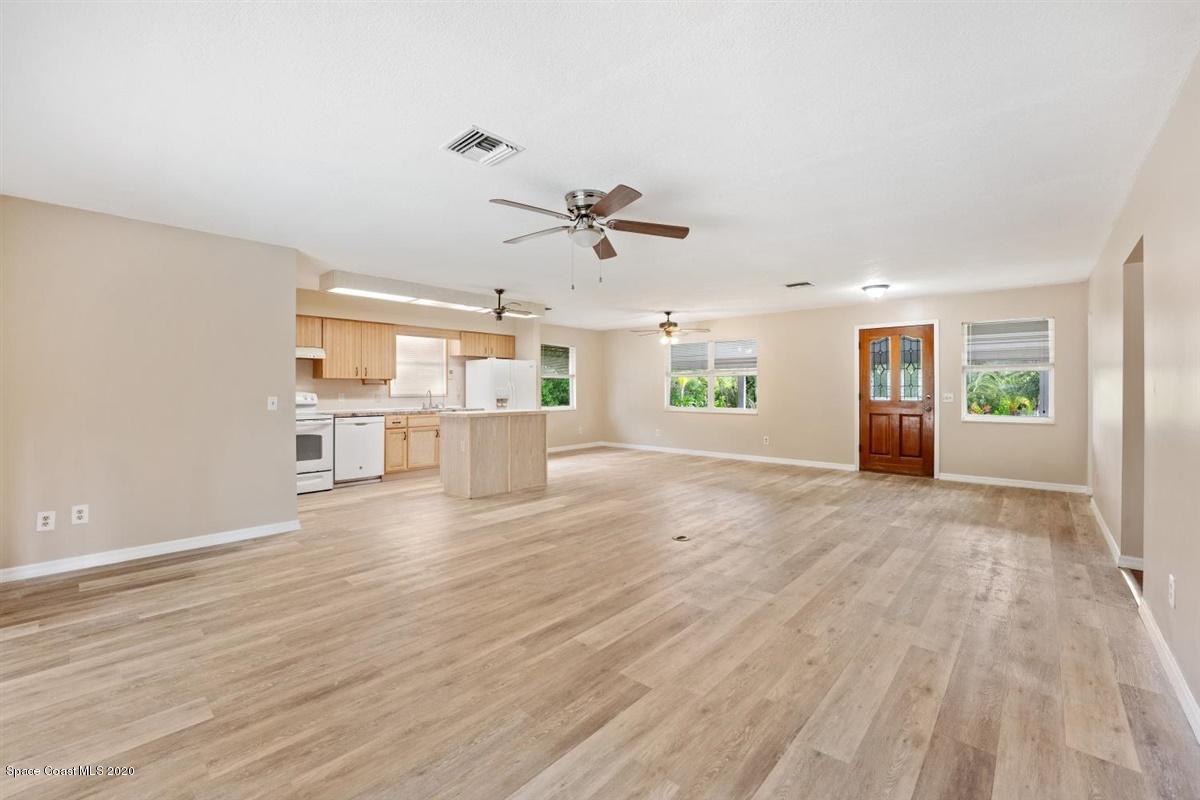 3600 Leghorn Road Grant Valkaria, FL 32950 - Photo 5 of 33 a view of an empty room with a window and wooden floor