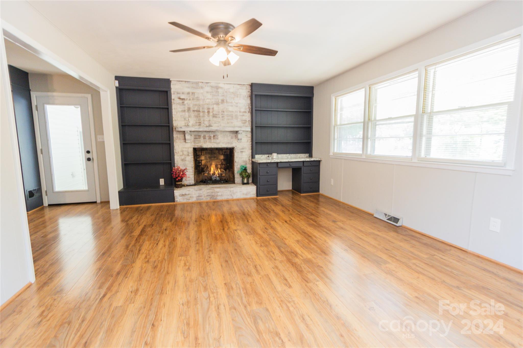 111 Colonial Avenue Lancaster, SC 29720 - Photo 12 of 40 a view of empty room with a fireplace and wooden floor