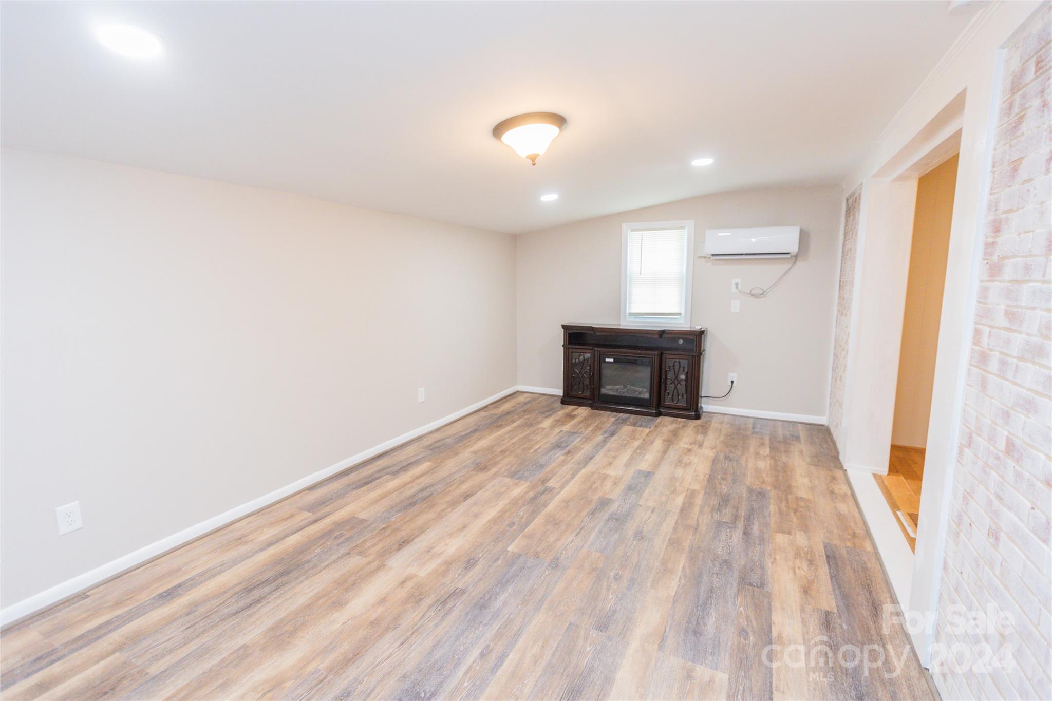 111 Colonial Avenue Lancaster, SC 29720 - Photo 15 of 40 wooden floor in an empty room with a window