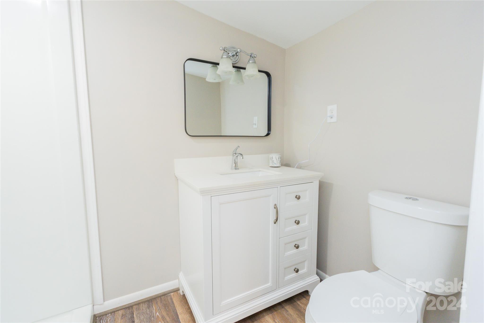 111 Colonial Avenue Lancaster, SC 29720 - Photo 18 of 40 a bathroom with a toilet sink vanity and mirror