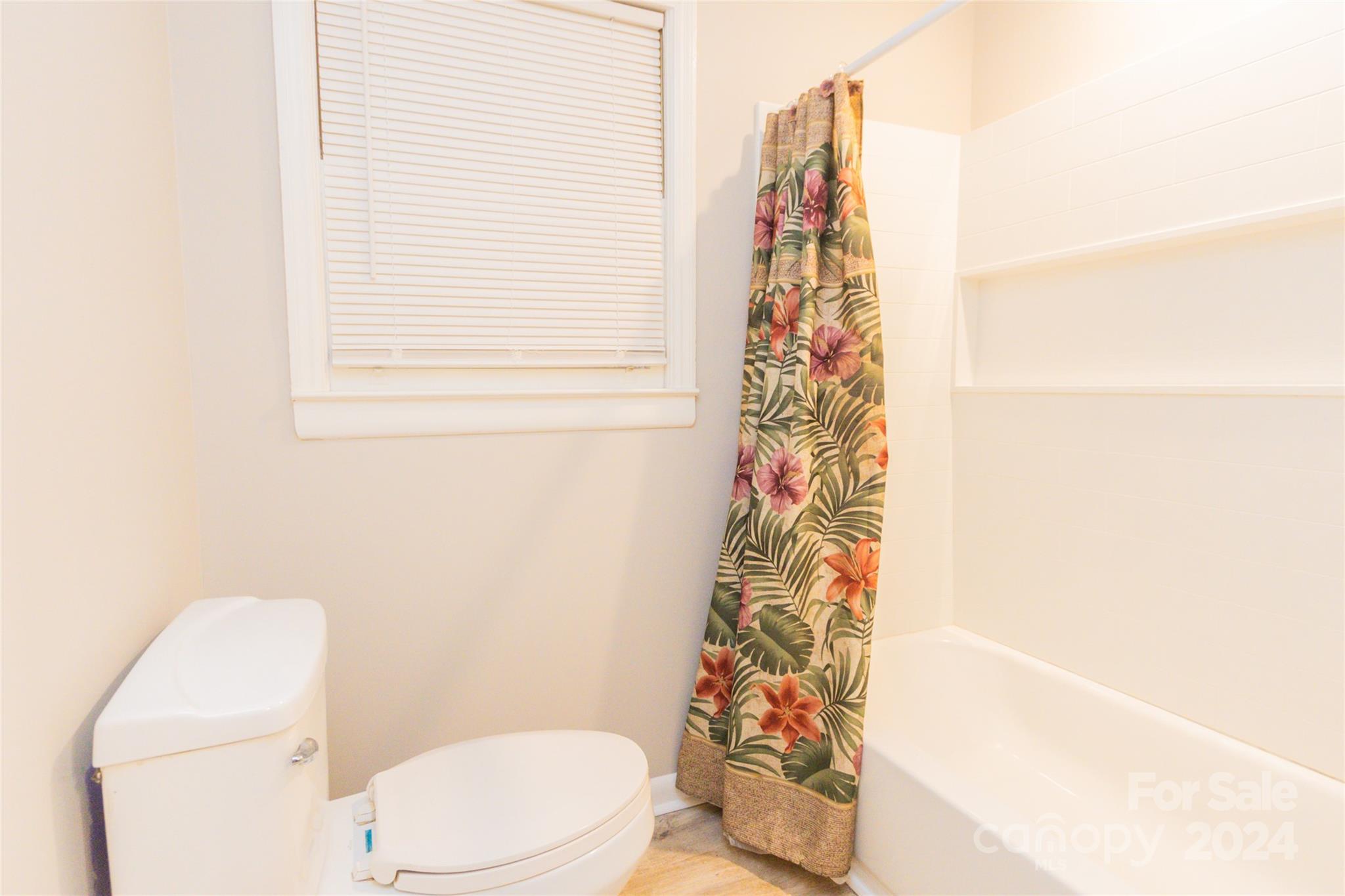 111 Colonial Avenue Lancaster, SC 29720 - Photo 21 of 40 a bathroom with a toilet and shower curtain