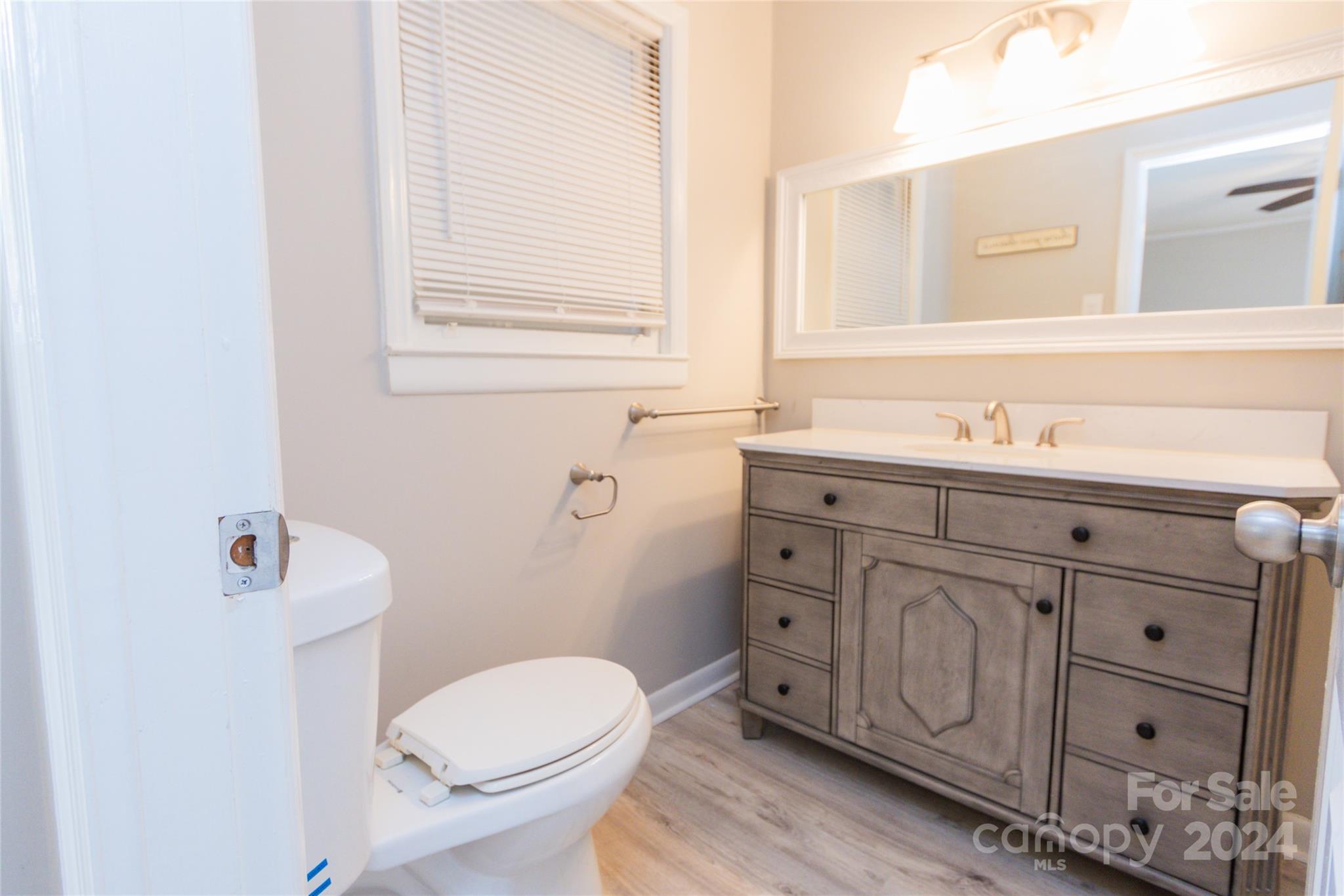 111 Colonial Avenue Lancaster, SC 29720 - Photo 26 of 40 a bathroom with a granite countertop toilet sink and mirror