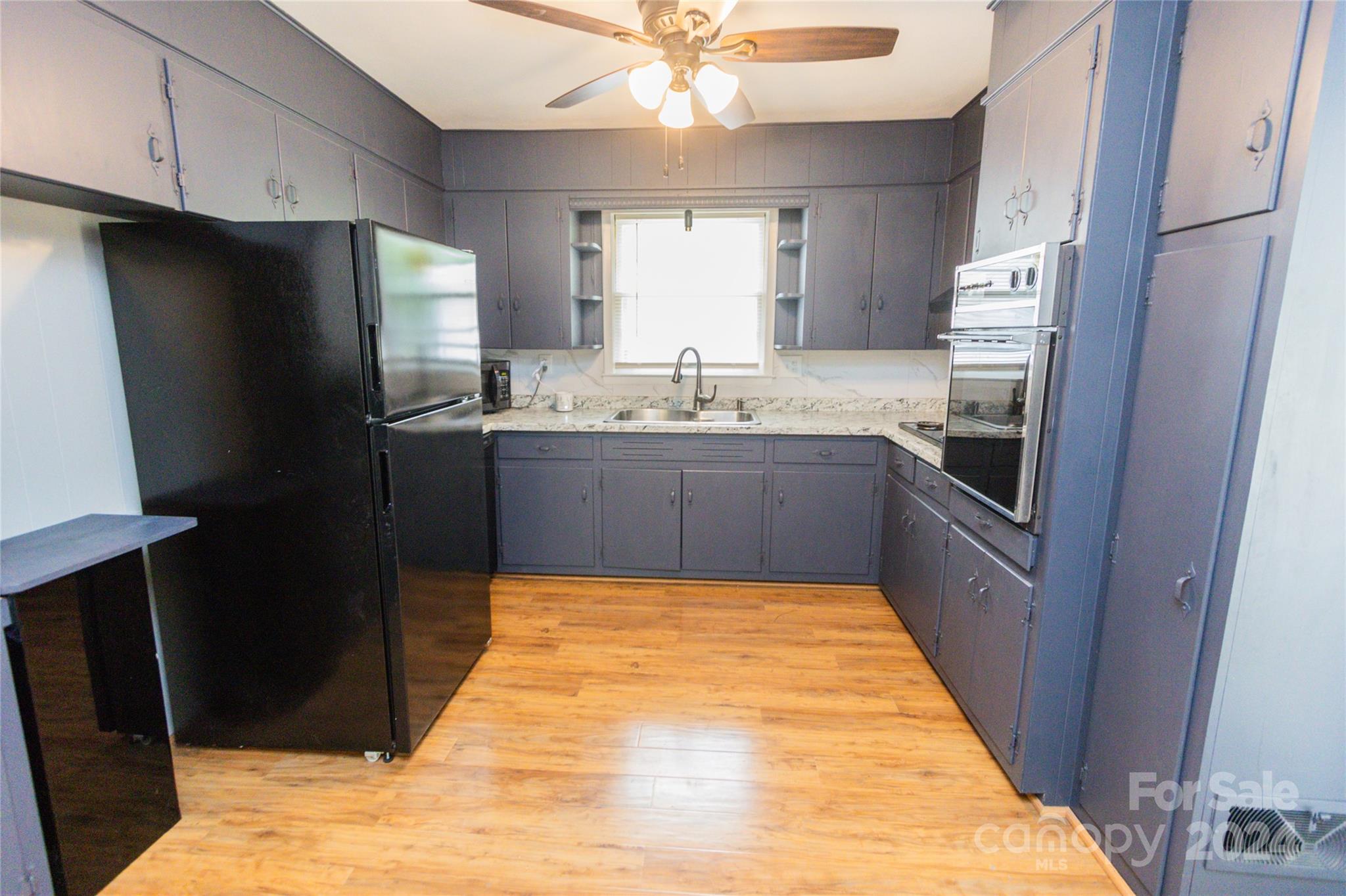 111 Colonial Avenue Lancaster, SC 29720 - Photo 3 of 40 a kitchen with stainless steel appliances granite countertop a refrigerator and a sink