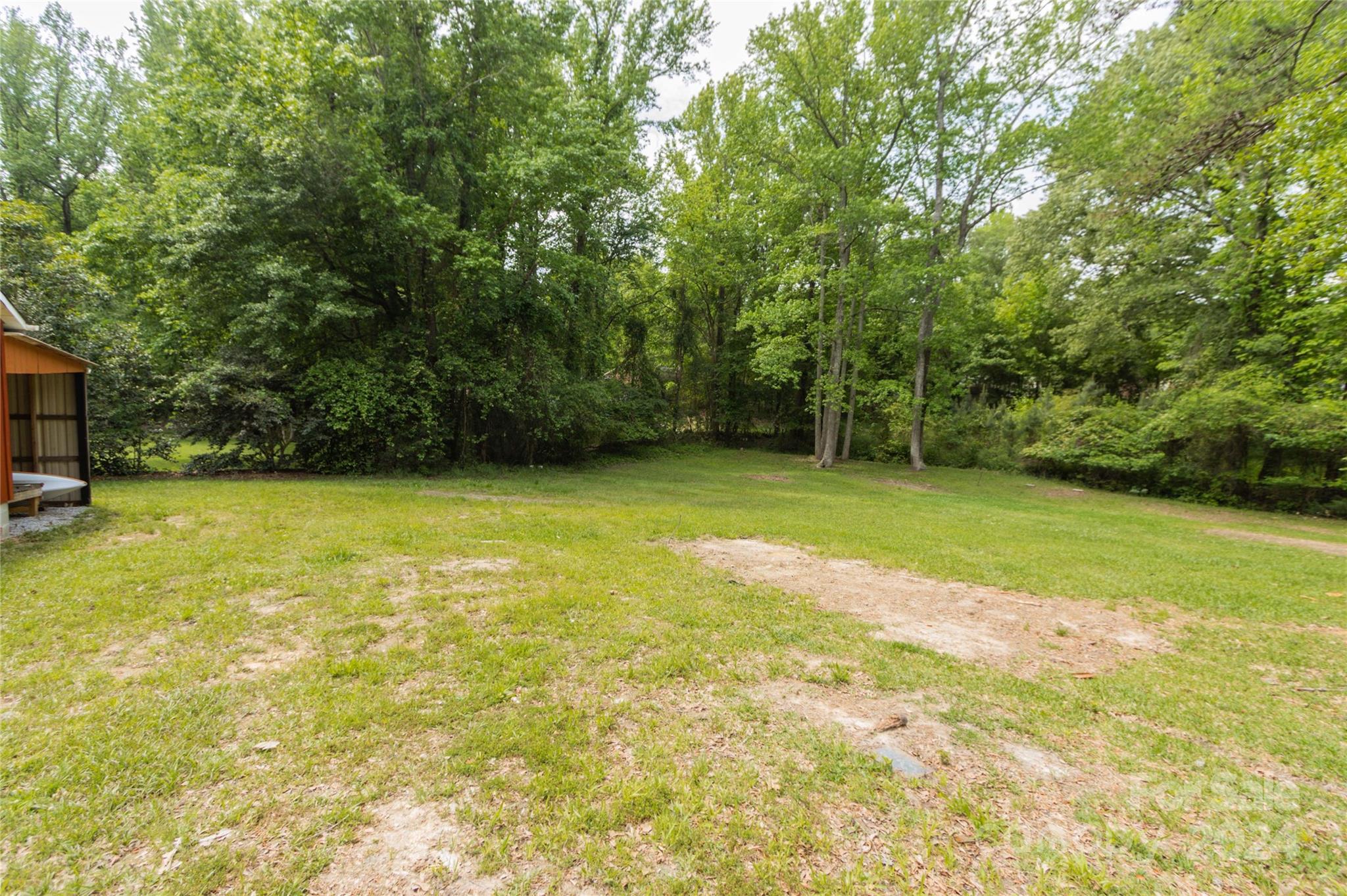 111 Colonial Avenue Lancaster, SC 29720 - Photo 36 of 40 a view of a field with trees in front of it