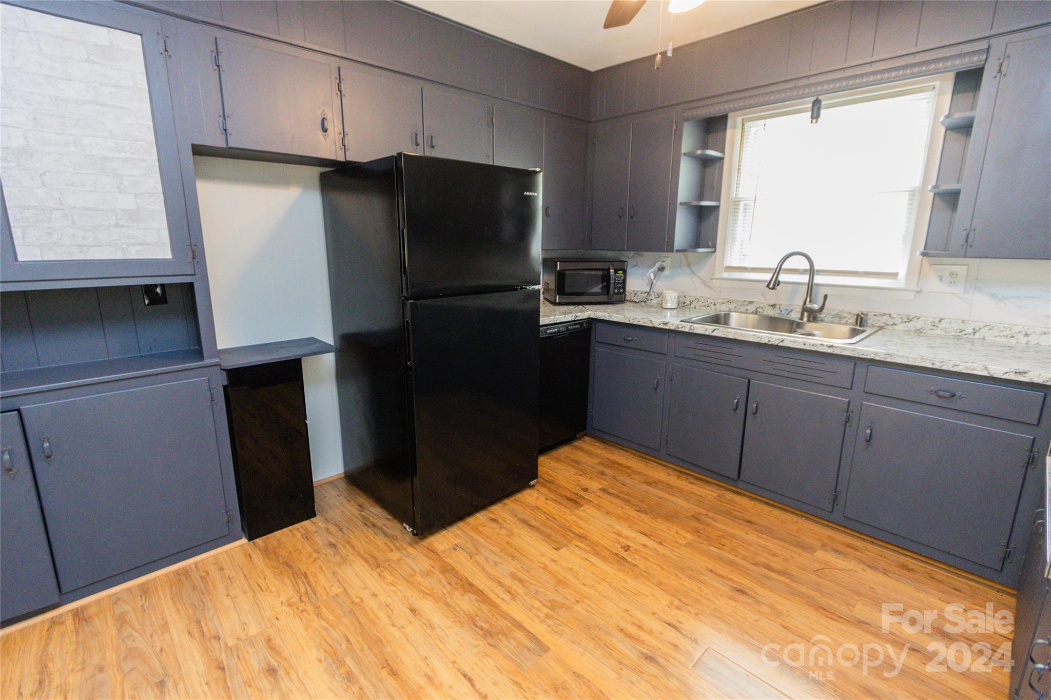 111 Colonial Avenue Lancaster, SC 29720 - Photo 4 of 40 a kitchen with a sink a refrigerator freezer a washer and dryer