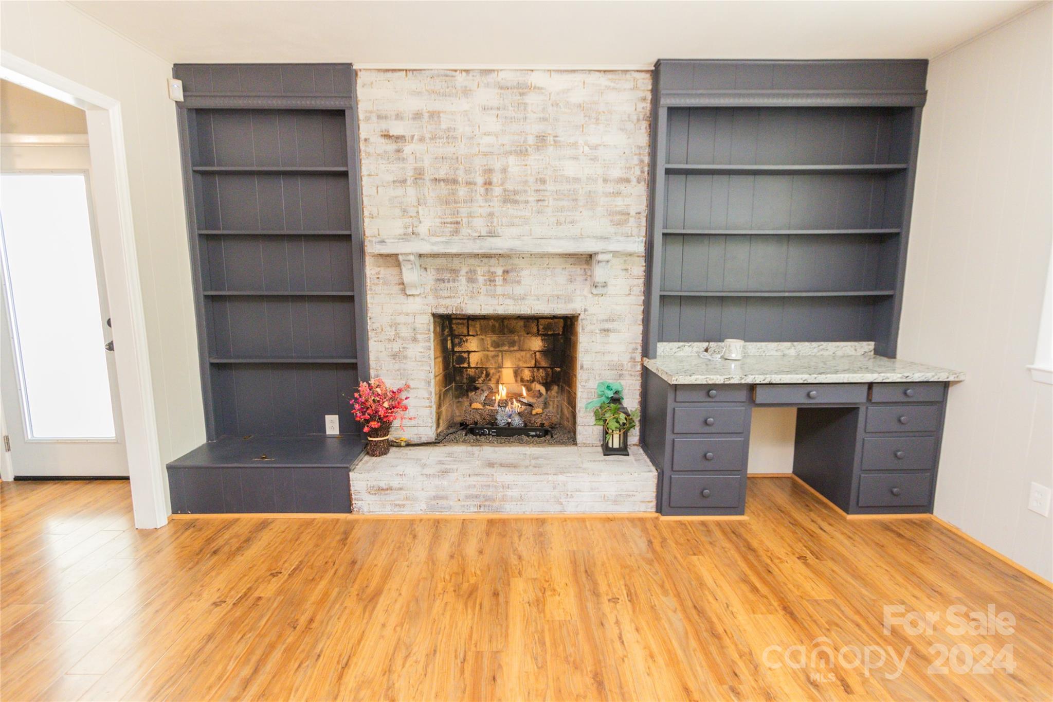 111 Colonial Avenue Lancaster, SC 29720 - Photo 8 of 40 a living room with a fireplace and a wooden floor